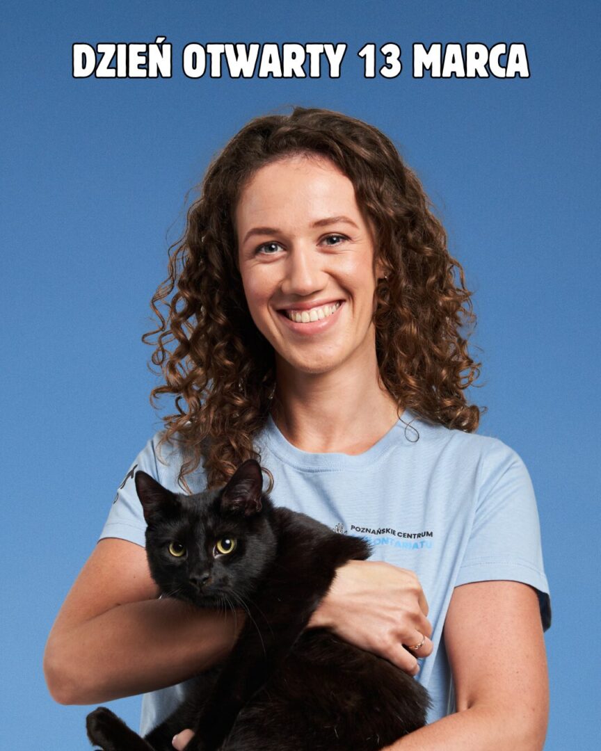 Plakat: dzień otwarty w PCW 13 marca 2026. Uśmiechnięta kobieta w koszulce z logo PCW. Na rękach trzyma czarnego kota.